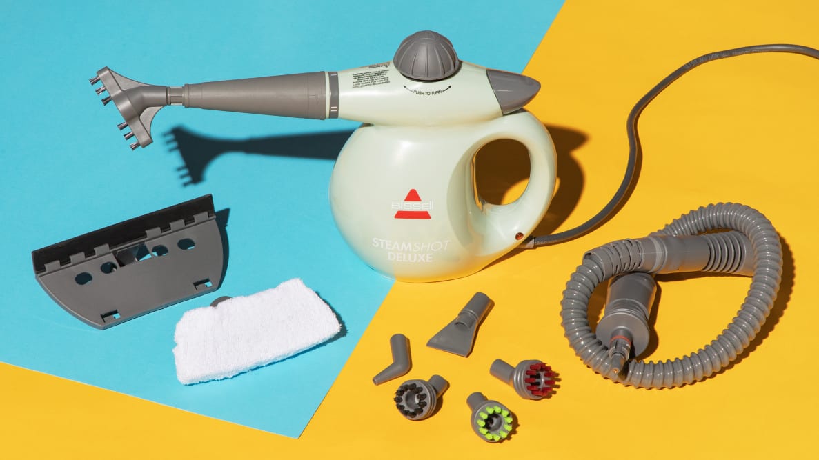 The Bissell Steam Shot Deluxe with its attachment heads against a blue and yellow background.