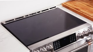 Close-up of the cooktop on a stainless steel induction range.