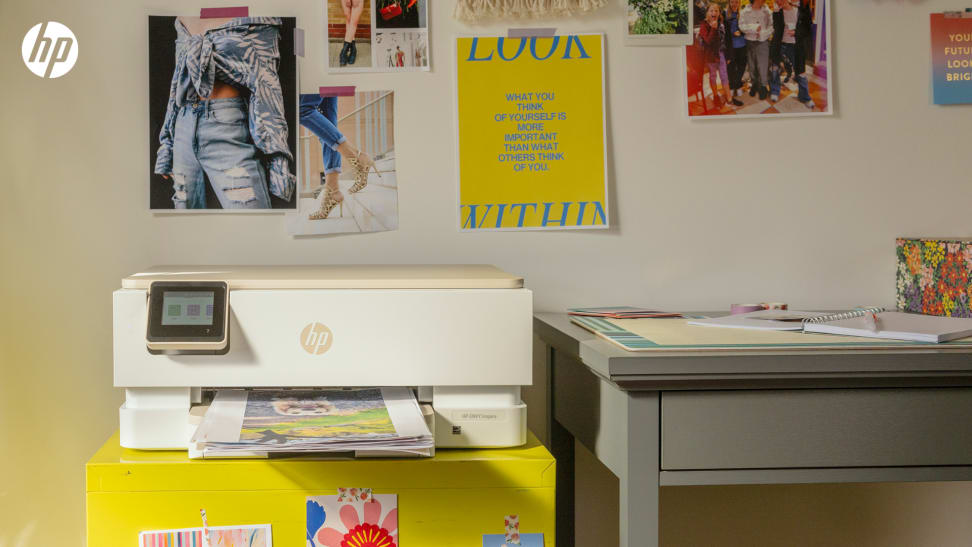 An HP Envy Inspire printer on a colorful desk setup, included with the HP All-In Plan subscription.