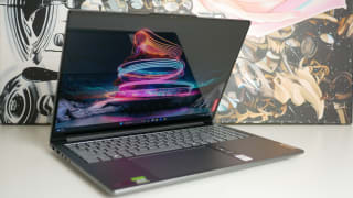 The Lenovo Yoga Pro 9i 16 Gen 9 half closed sitting atop a table.