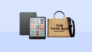 An Amazon Kindle Colorsoft and Marc Jacobs tote on an indigo background